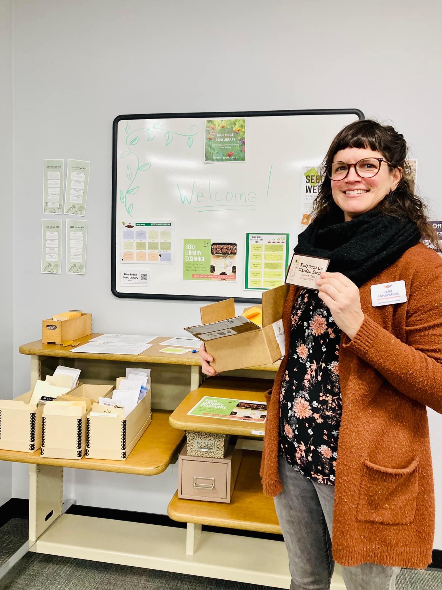 Electronic Resources Librarian Julia Haverstock stands next to the seed library at Blue Ridge Community College 