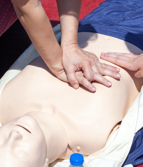 Person doing CPR compressions on a dummy