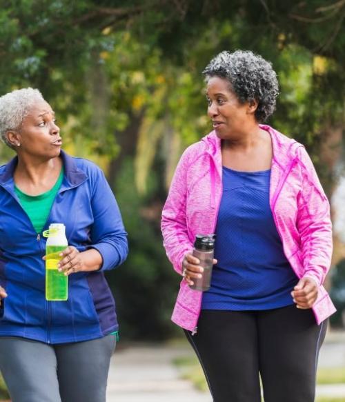 Two older adults walking. Credit: Standing Strong NC