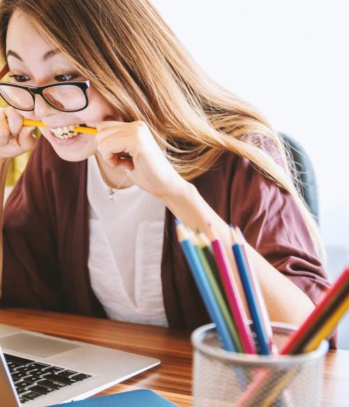 Young woman studying on laptop