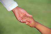 Child holding adults hand